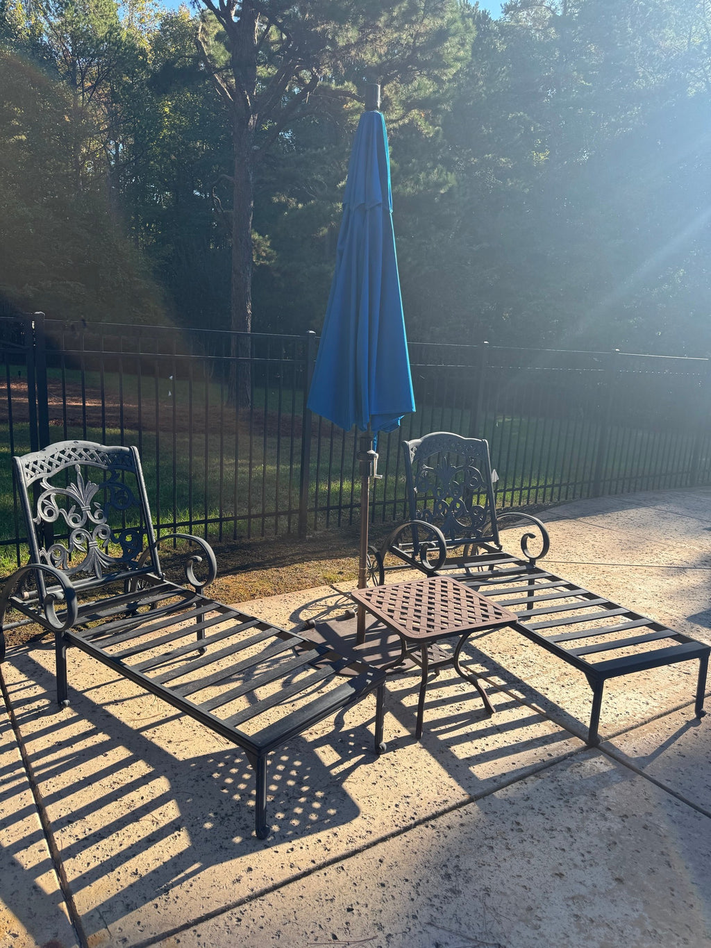 Two Cast Aluminum Chaise Loungers, Scrollwork, with Side Table and Umbrella, Poolside