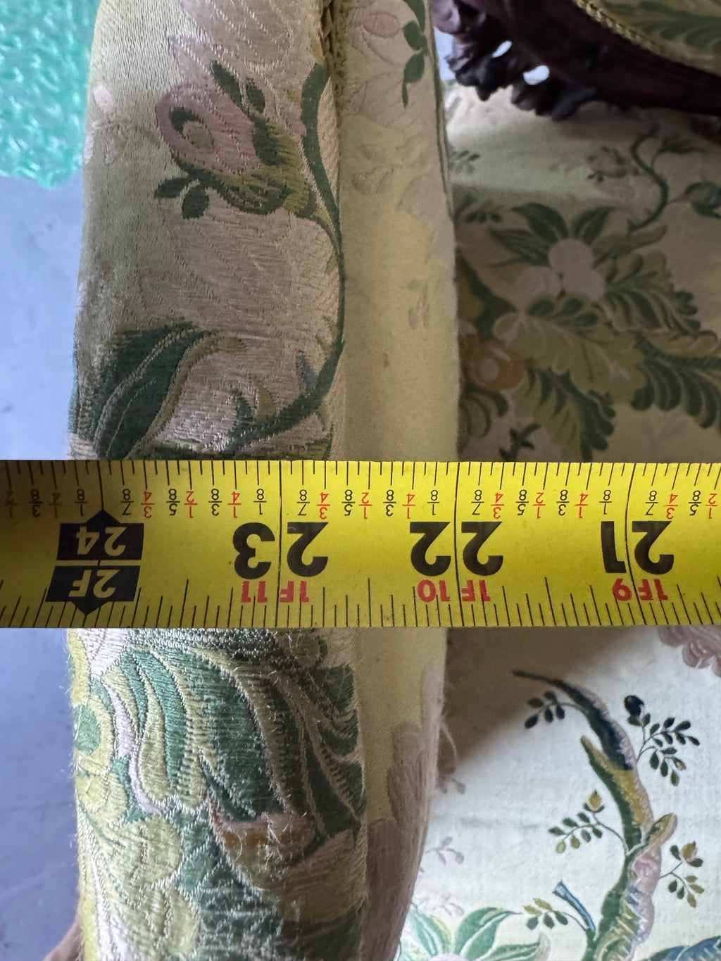 Tape measure across the arms, recording the chair's width