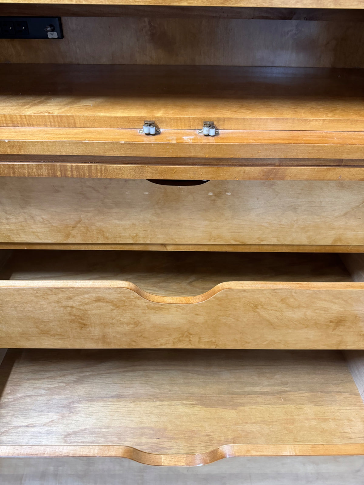 Interior storage area with open shelving and lower drawer access visible