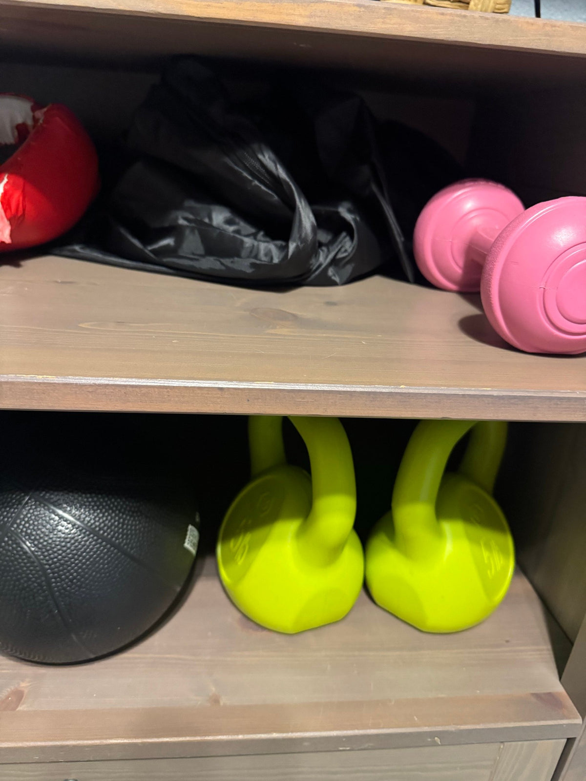 Kettlebells, medicine ball and pink dumbbell