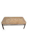 Marble-top coffee table in front of a fireplace