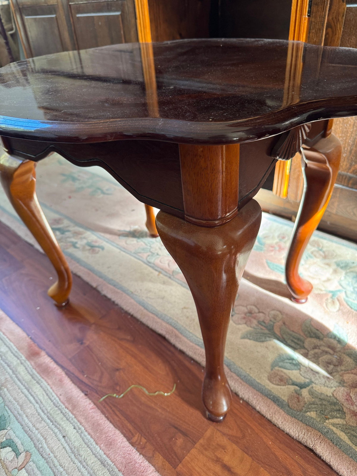 Close view of a cabriole leg and the scalloped top edge