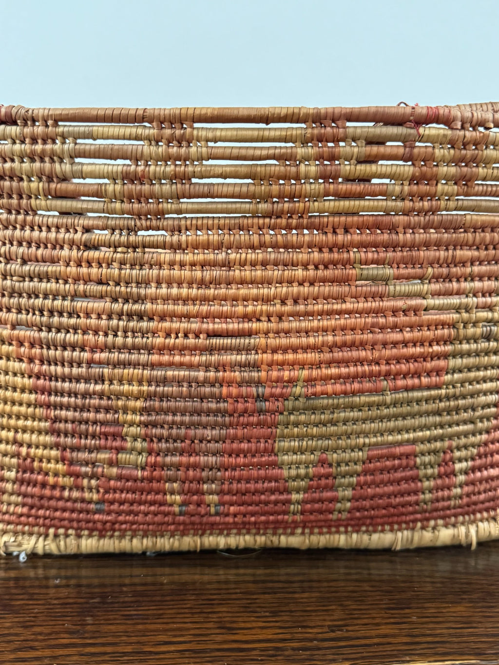 Basket handles from above showing wrapped fiber construction and connection to basket body