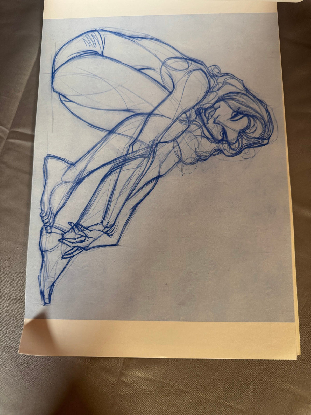 Blue-pencil seated figure drawing