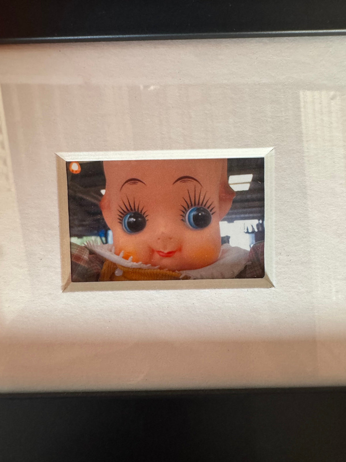 Close view of the kewpie-style doll photograph