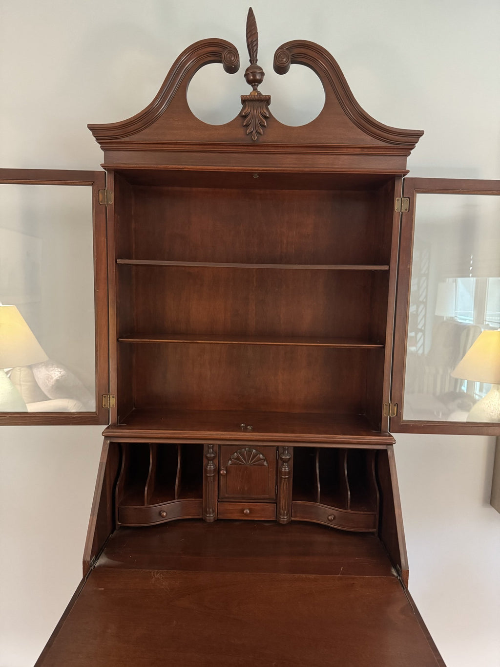 Fitted interior with pigeonholes and a shell-carved centre door behind the slant front