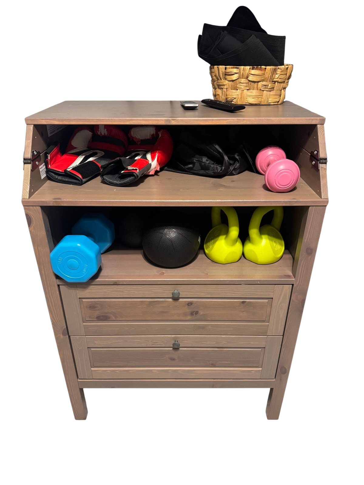 Two-drawer wood cabinet with an open top shelf holding gym gear