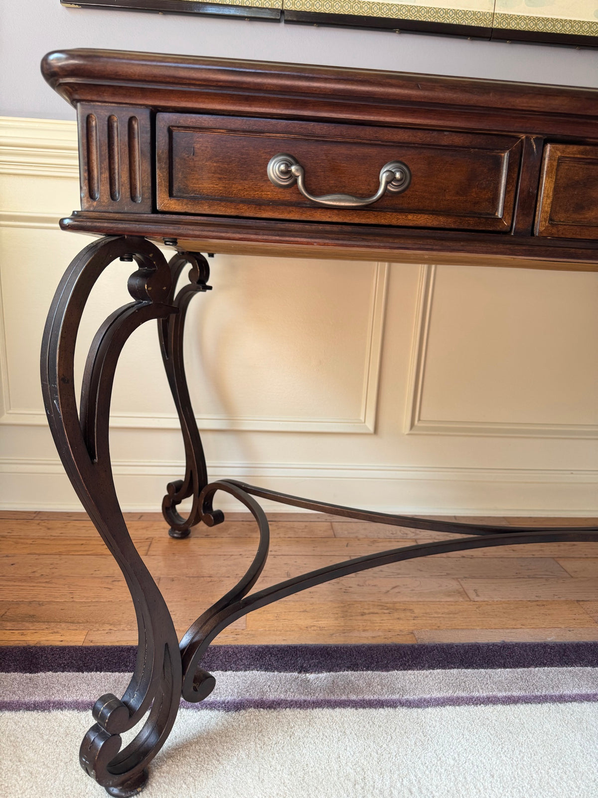 Close-up detail of left carved leg with scrolled bracket foot and decorative metalwork