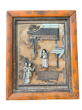 Framed carved wooden panel with pagoda roof, figures, and architectural details in relief, orange wood frame with patina