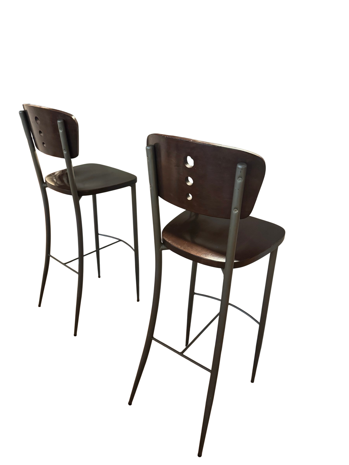 Pair of bar stools with espresso wood seats and gray metal legs at a kitchen counter, viewed from behind