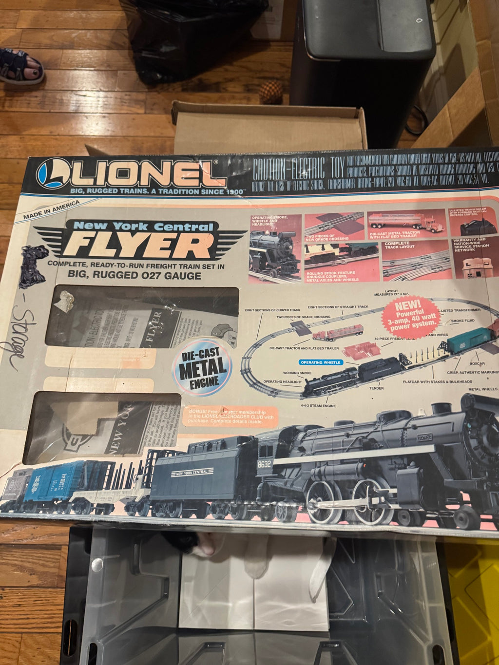Same boxed train set displayed on wooden floor, angled view showing full box front and packaging details
