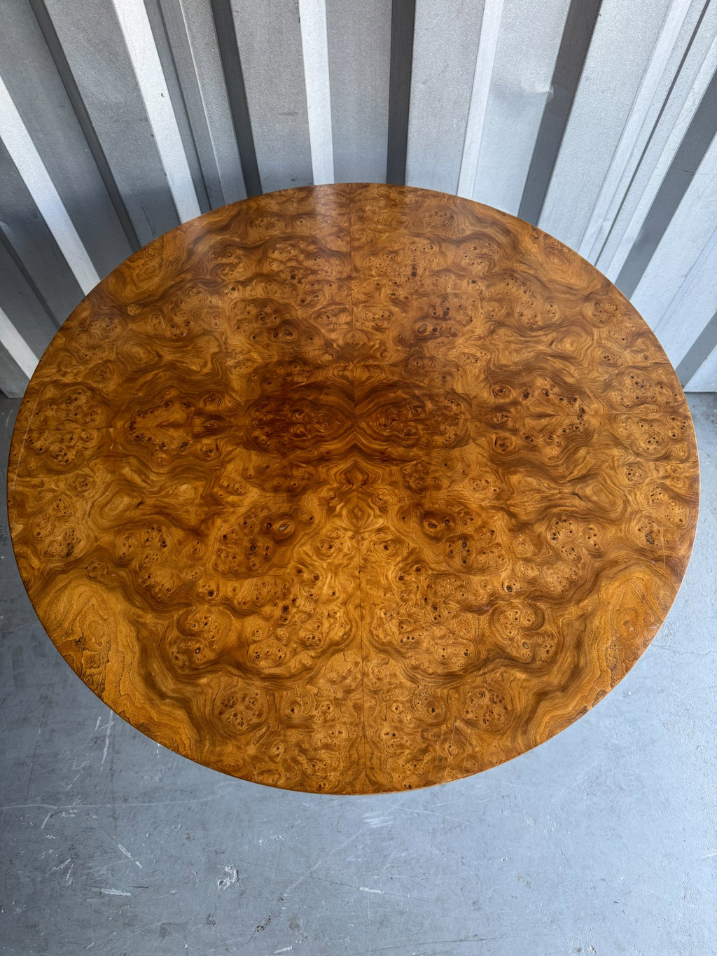 Tabletop surface viewed from directly above, showcasing complex burl wood grain and swirling patterns throughout