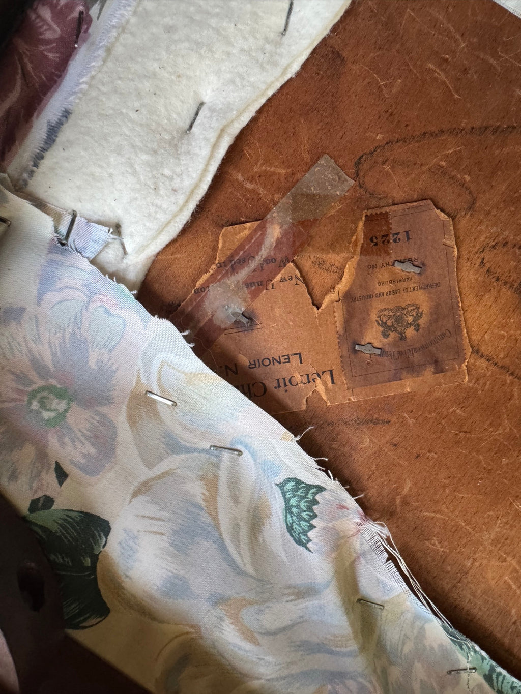 Aged leather label on underside showing partial text including 'LENOIR' and maker's mark stamp