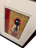Framed gas-mask figure on a red and mustard ground in a dark wood frame with cream mat