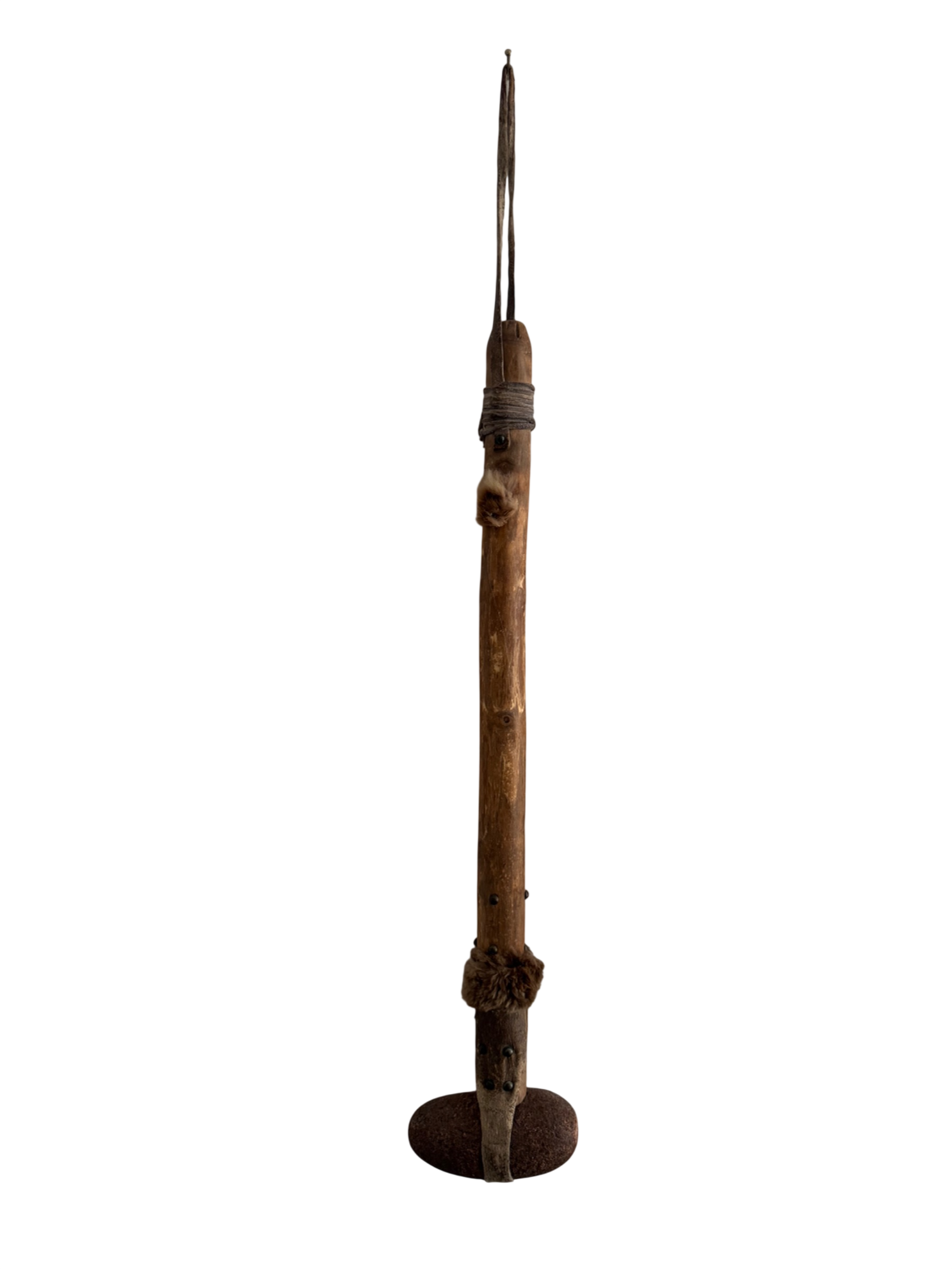 Antique wooden distaff spinning tool displayed full length against white background, showing long shaft, fur binding, and iron base