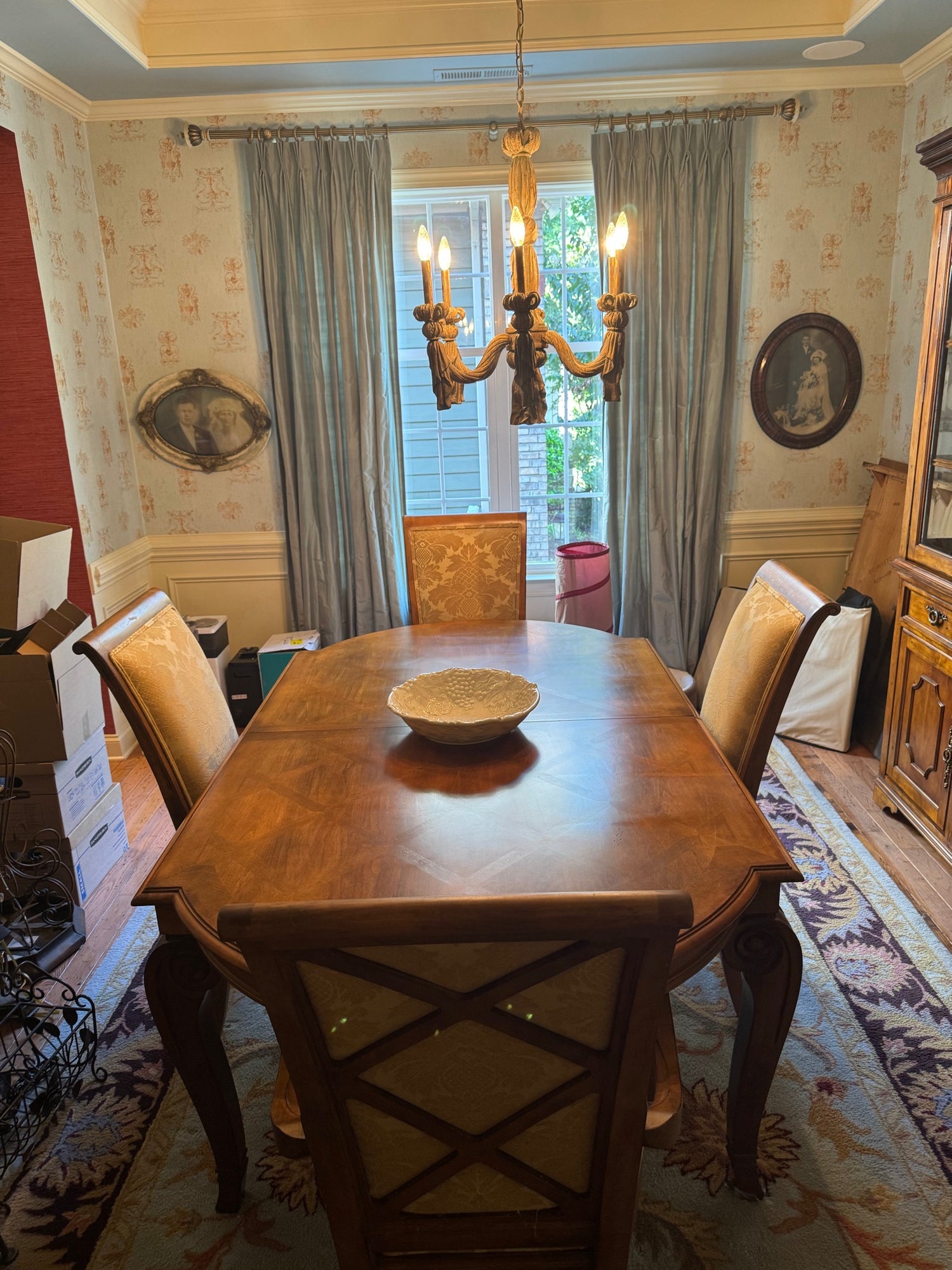 Dining table and chairs from elevated angle showing parquet top, upholstered seat backs, formal room setting