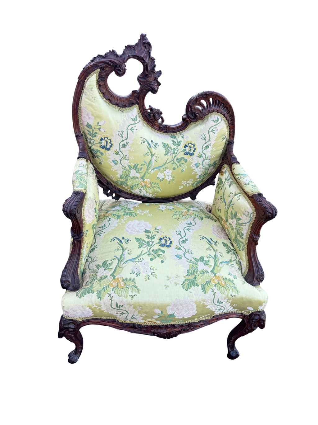 Antique carved walnut ram's head armchair, Rococo Revival, seen from the front with its asymmetrical pierced crest and green silk brocade upholstery