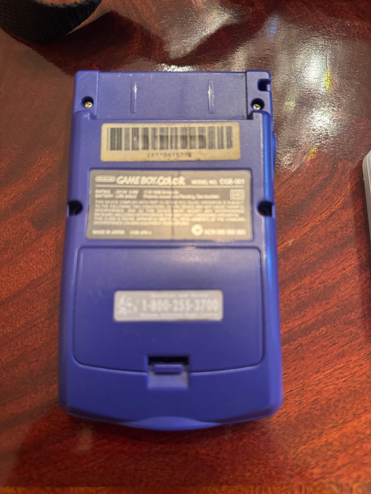 Back of the purple Nintendo Game Boy Color showing model label CGB-001 and barcode sticker