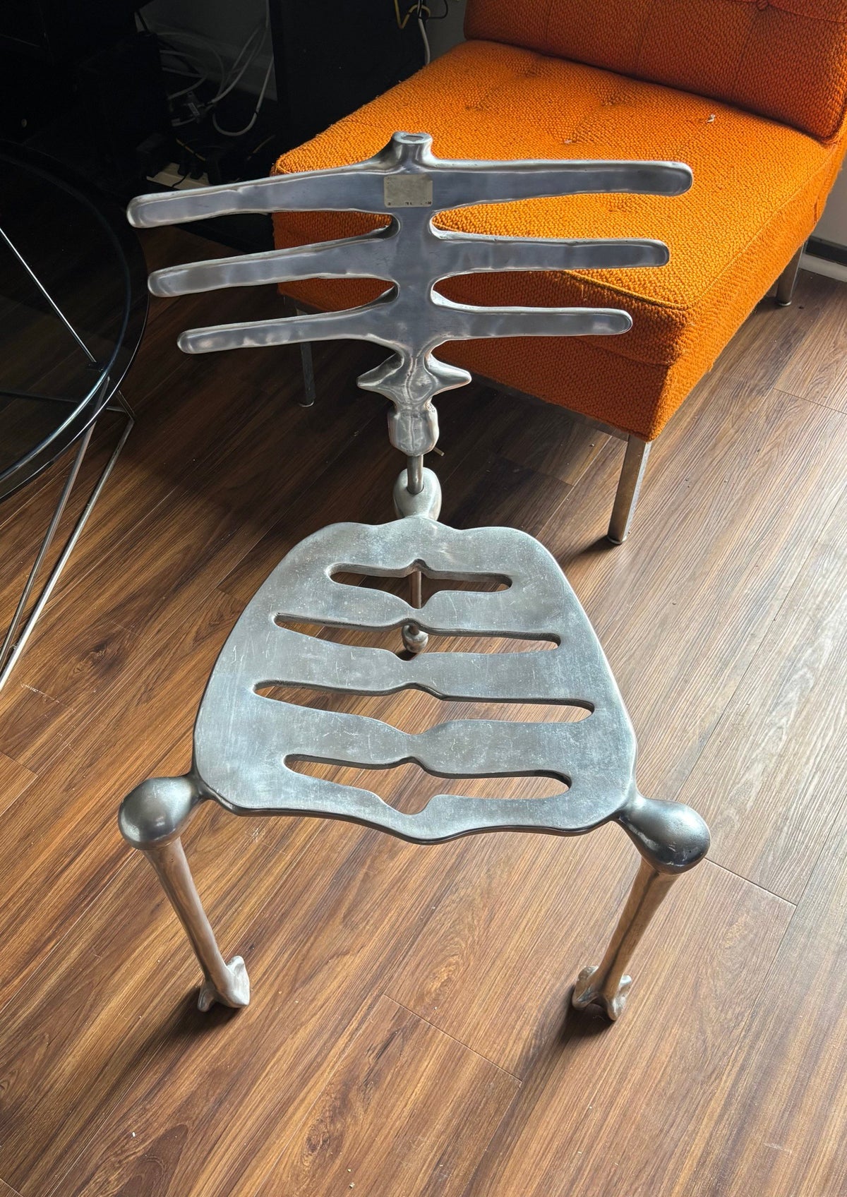 Skeleton chair indoors, front angle