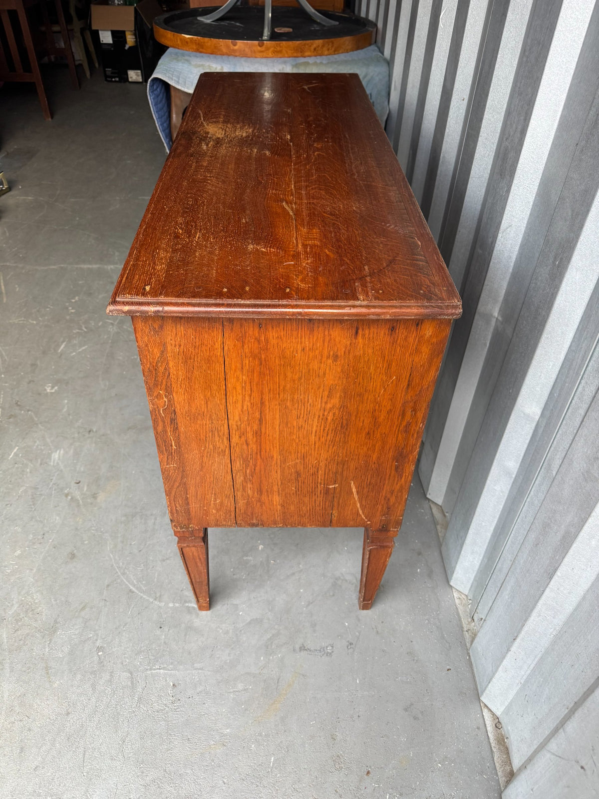 Back view showing simple construction with natural wood and tapered leg supports