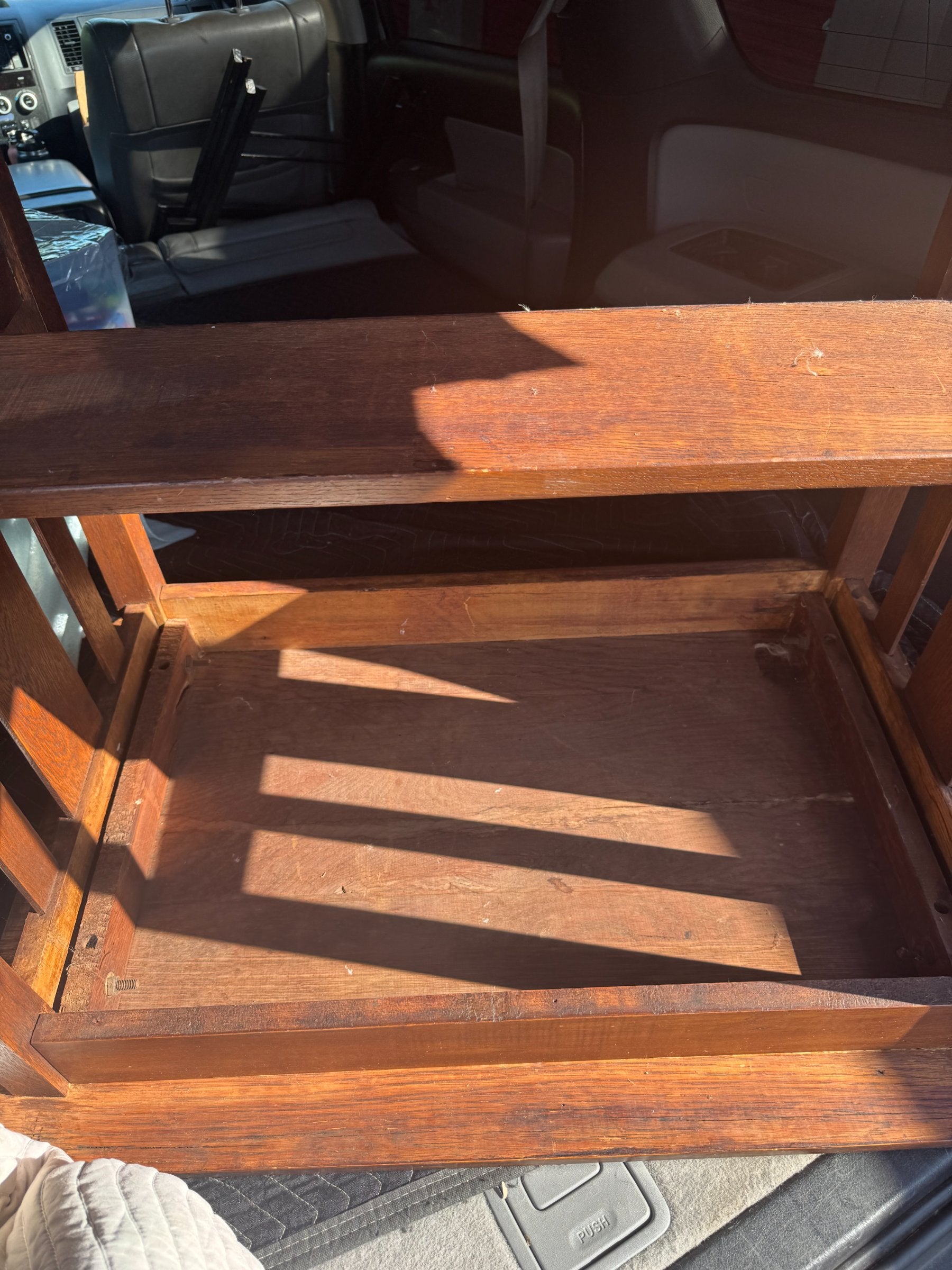 Close-up of table leg and shelf connection, showing mortise and tenon joinery and wood grain detail