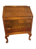 Birdseye maple slant-front desk seen from the front on cabriole legs