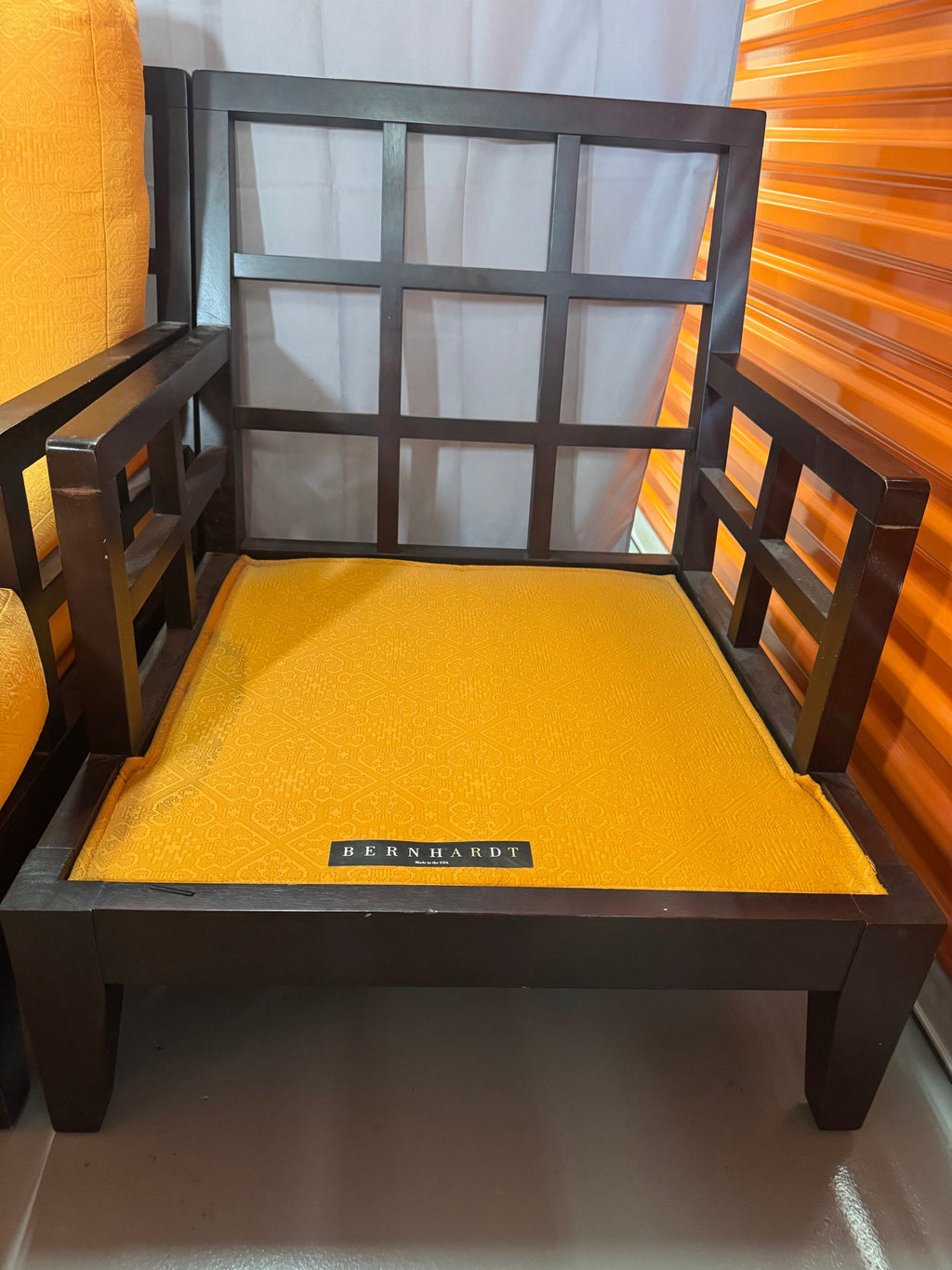 Chair seat with Bernhardt label and window-grid arm panel