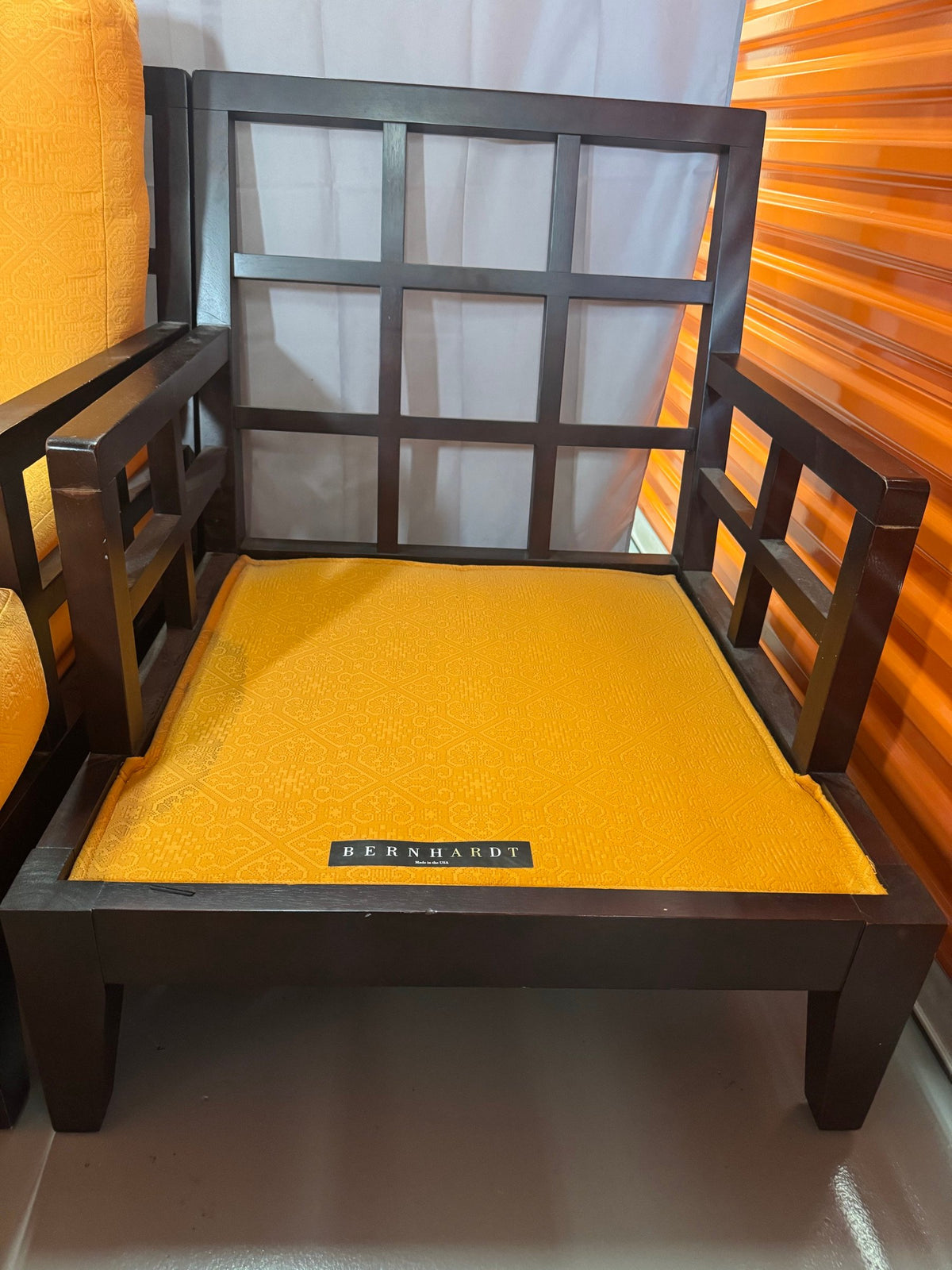 Chair seat with Bernhardt label and window-grid arm panel