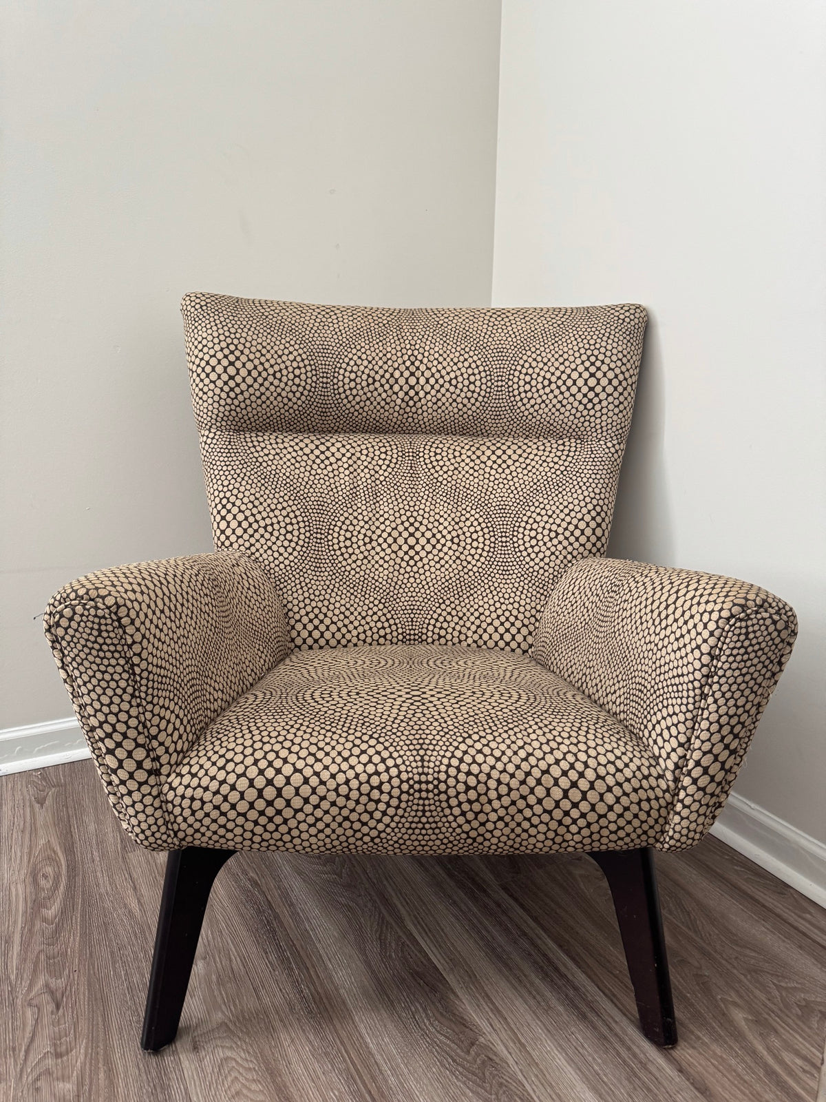 Interior view of chair seat and back cushions with cream and black dot fabric pattern