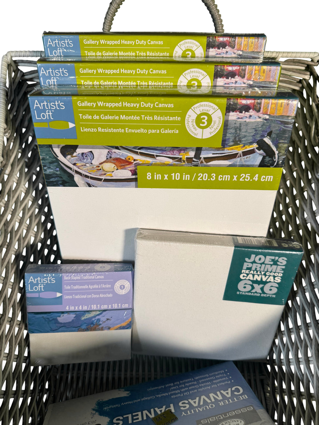 Art Supply Lot Canvases Panels and Tools in Wicker Basket — main image on a white ground