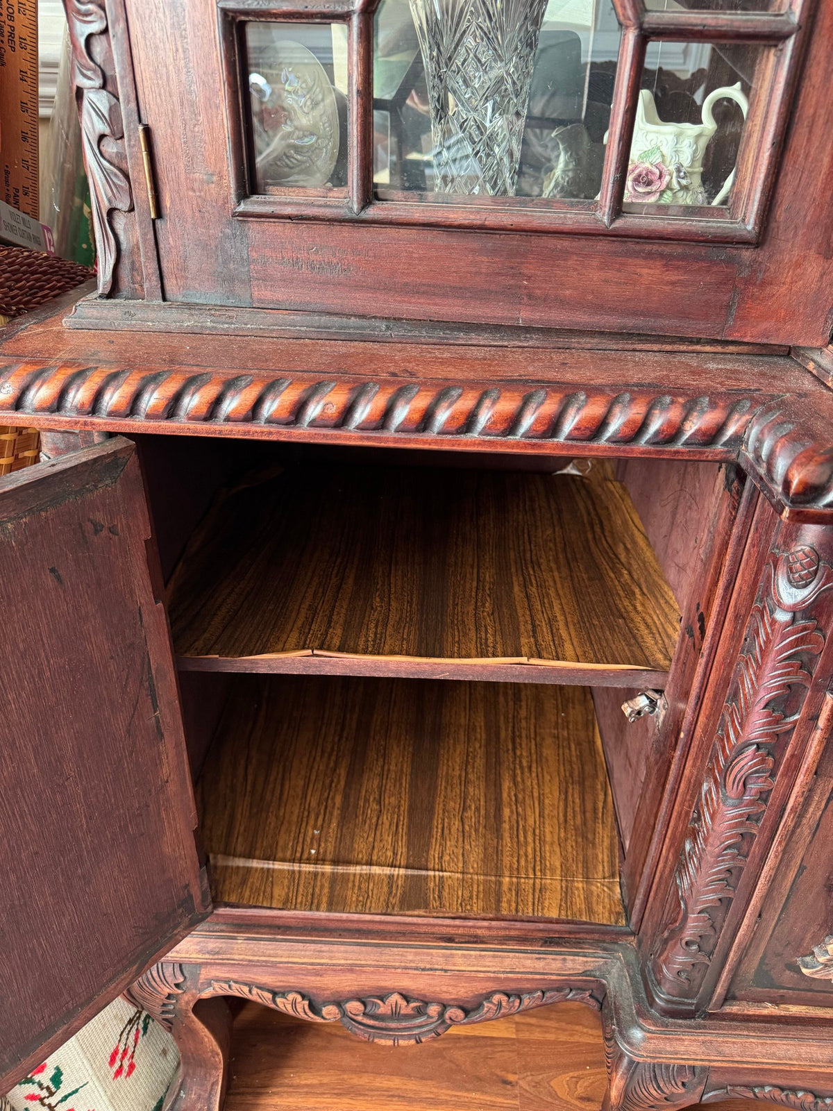 Open lower cabinet showing wood-lined shelves