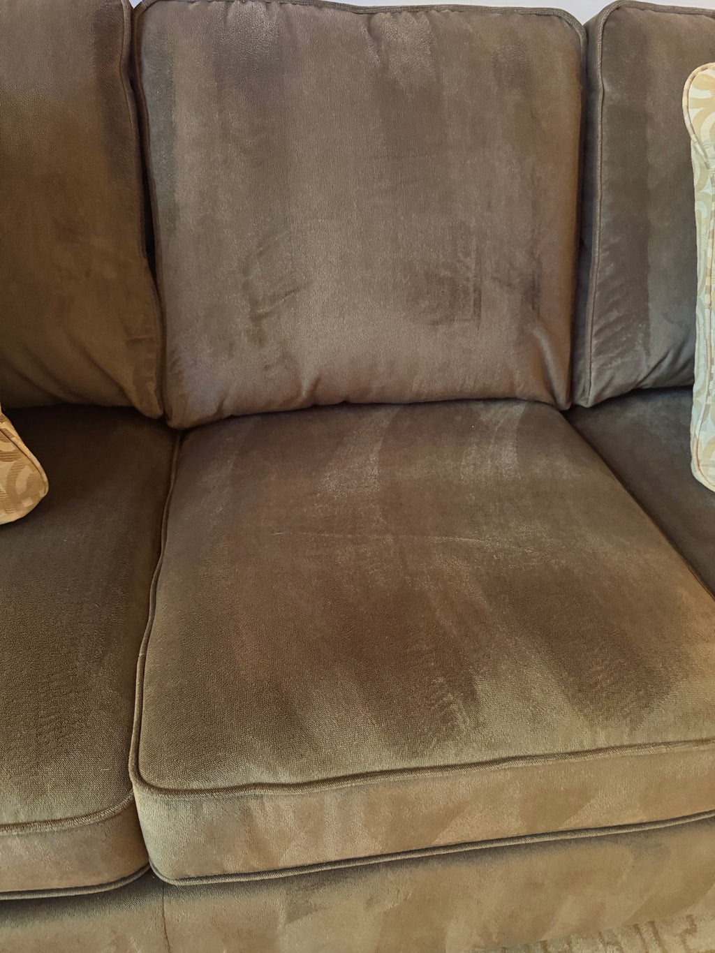 Close-up of sofa seat and back cushions showing watermark-style shading on microfiber fabric