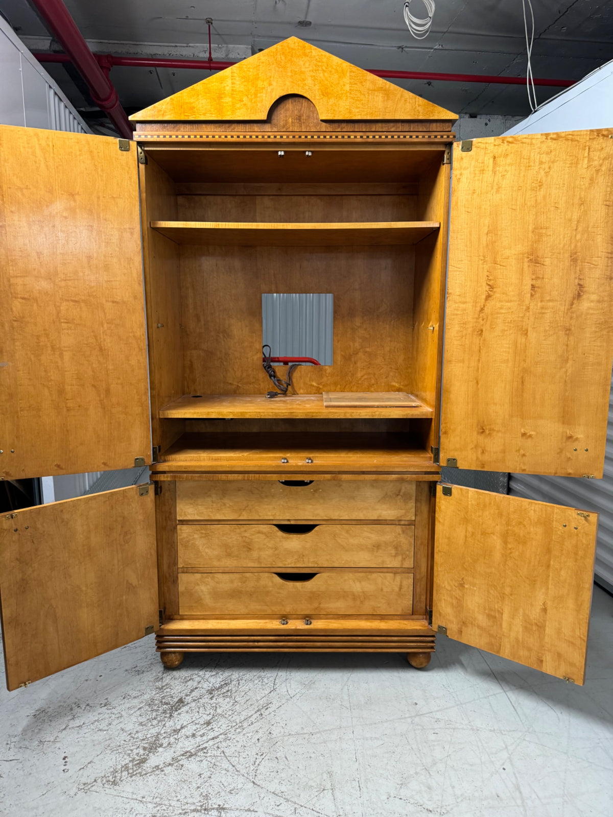 All four open doors revealing interior drawers, shelves and storage compartments