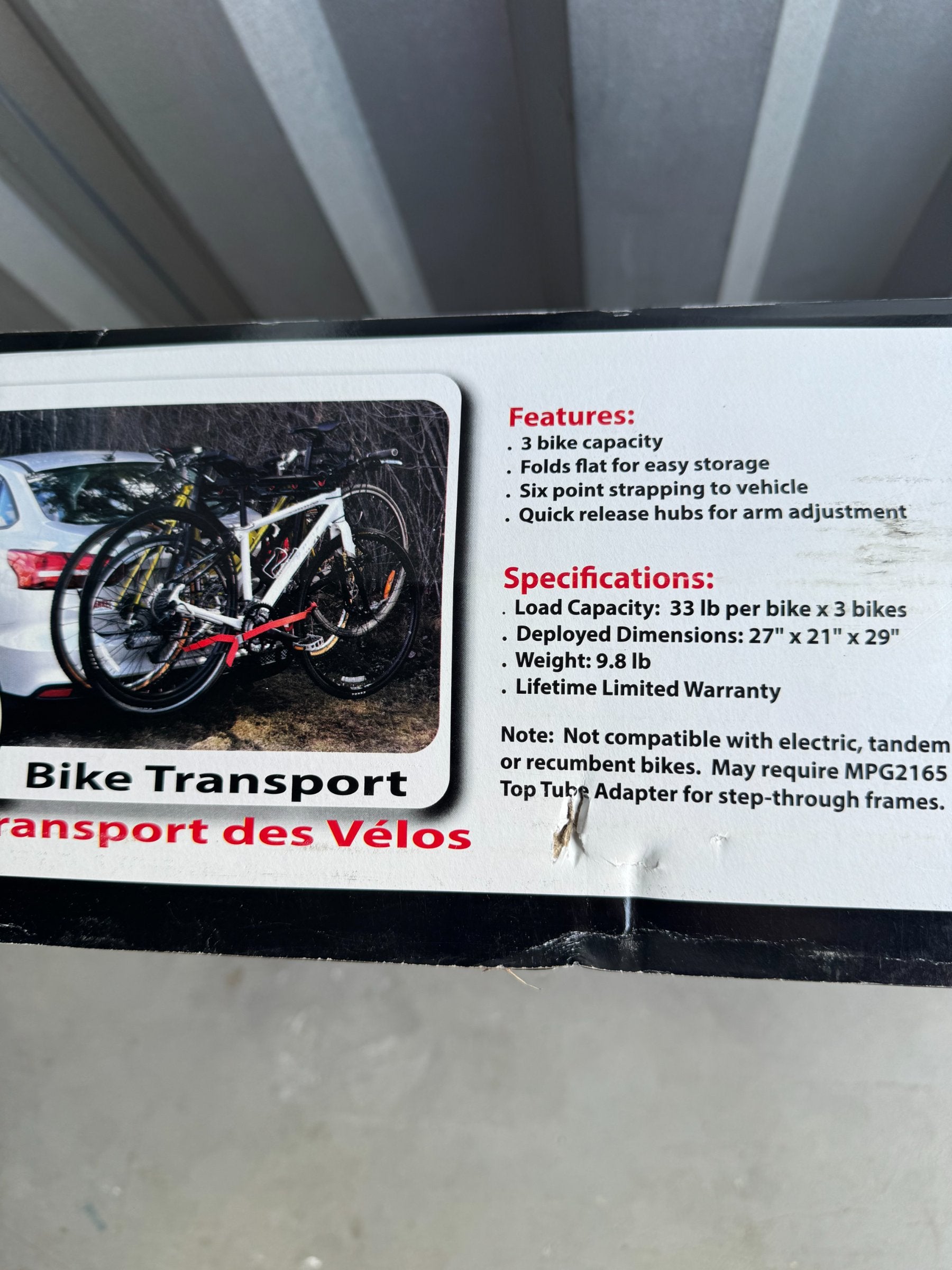 Box back panel displaying bike carrier features, load capacity of 33 lb per bike, dimensions, weight, and warranty information