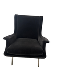 Black wingback accent chair on metal legs, three-quarter view