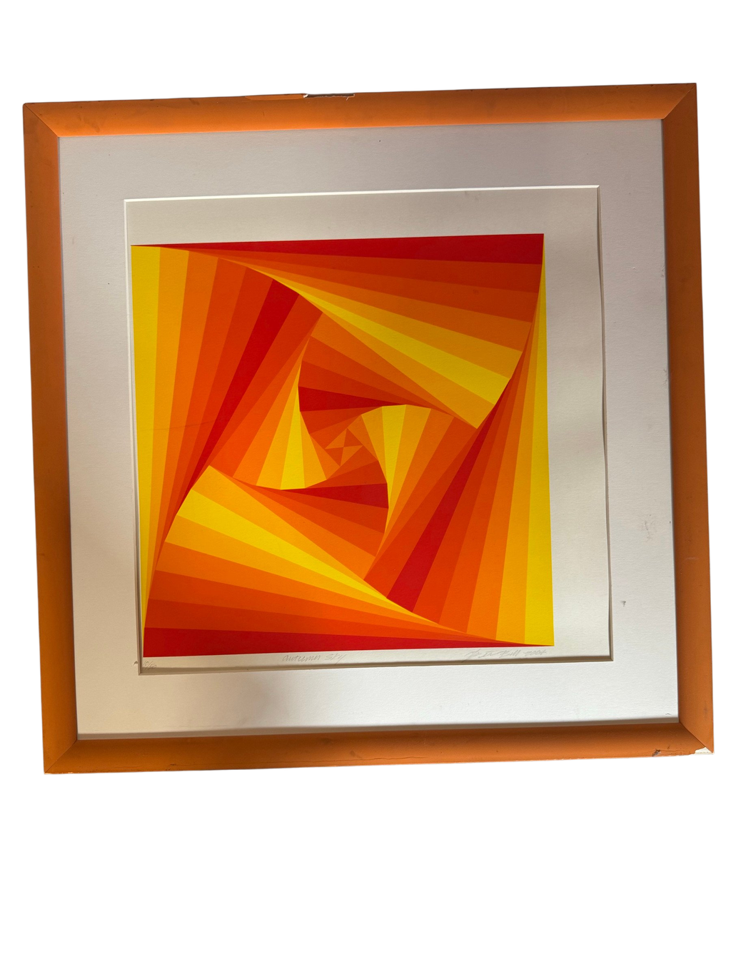 Orange op-art spiral serigraph in orange frame, straight-on