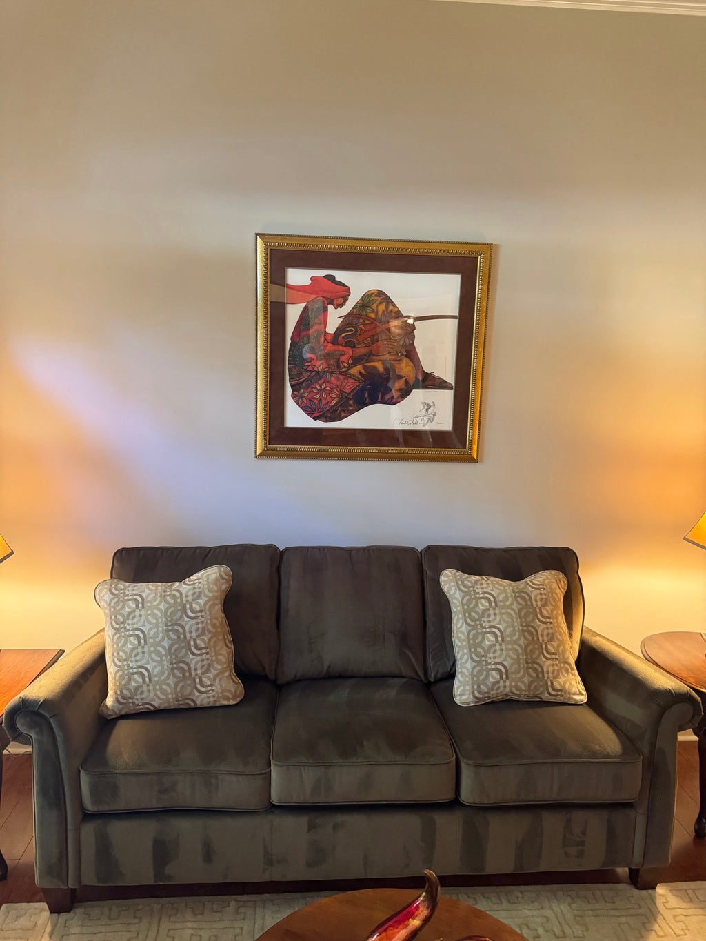 Front view of olive brown microfiber sofa with rolled arms and two accent pillows