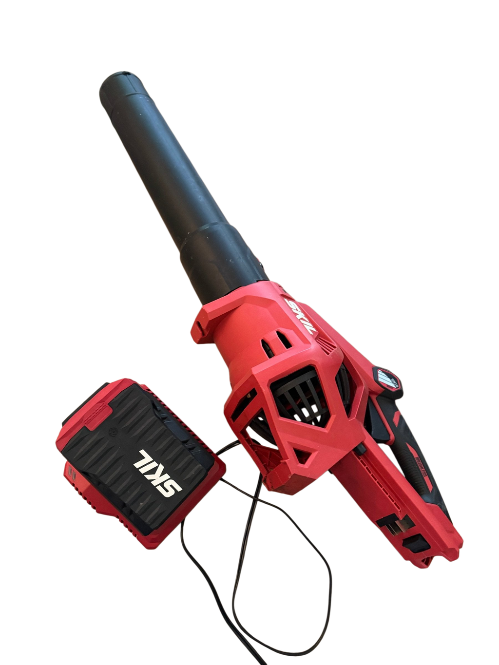 SKIL cordless leaf blower with battery and charger on a stone-top table