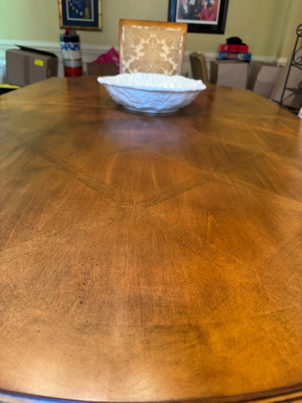 Close-up of parquet wood tabletop showing geometric inlay pattern and wood grain detail