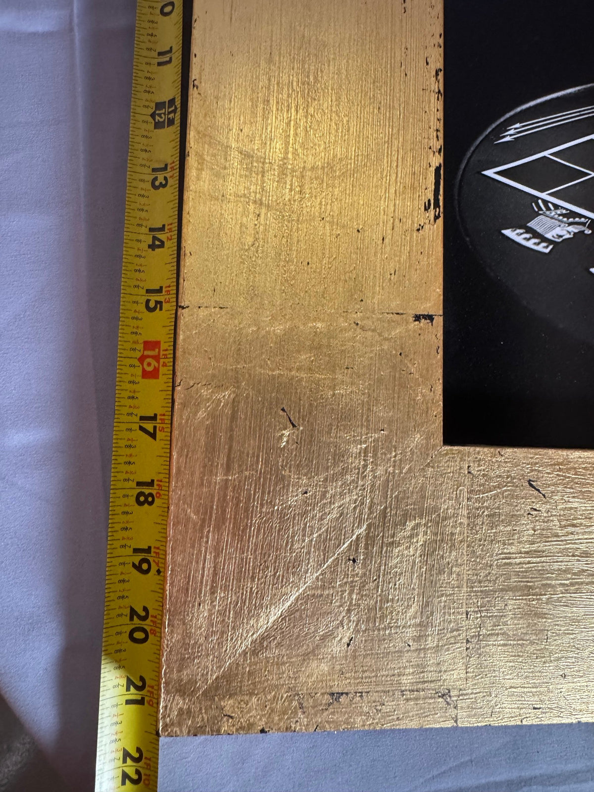 Tape measure held against the frame showing its size