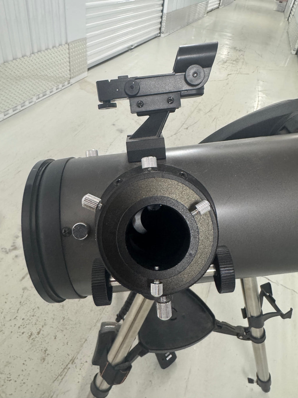 Rear view of telescope tube showing eyepiece focuser with adjustment knobs and diagonal mirror