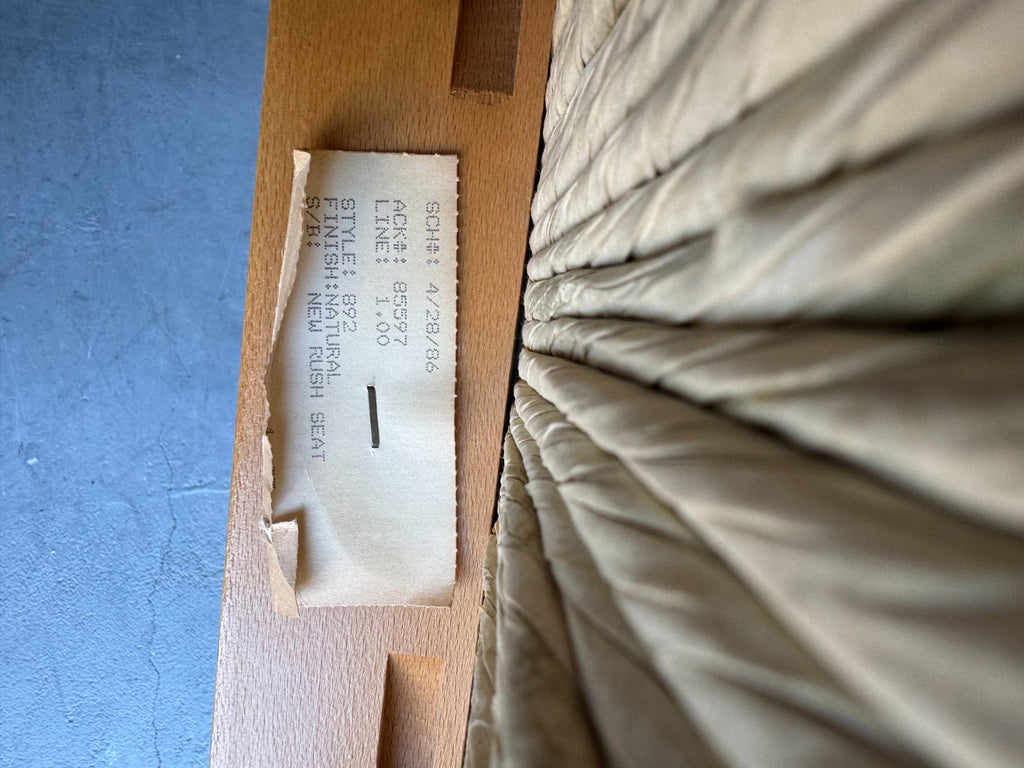 Maker's label on underside of stool showing text and manufacturer details, partially visible