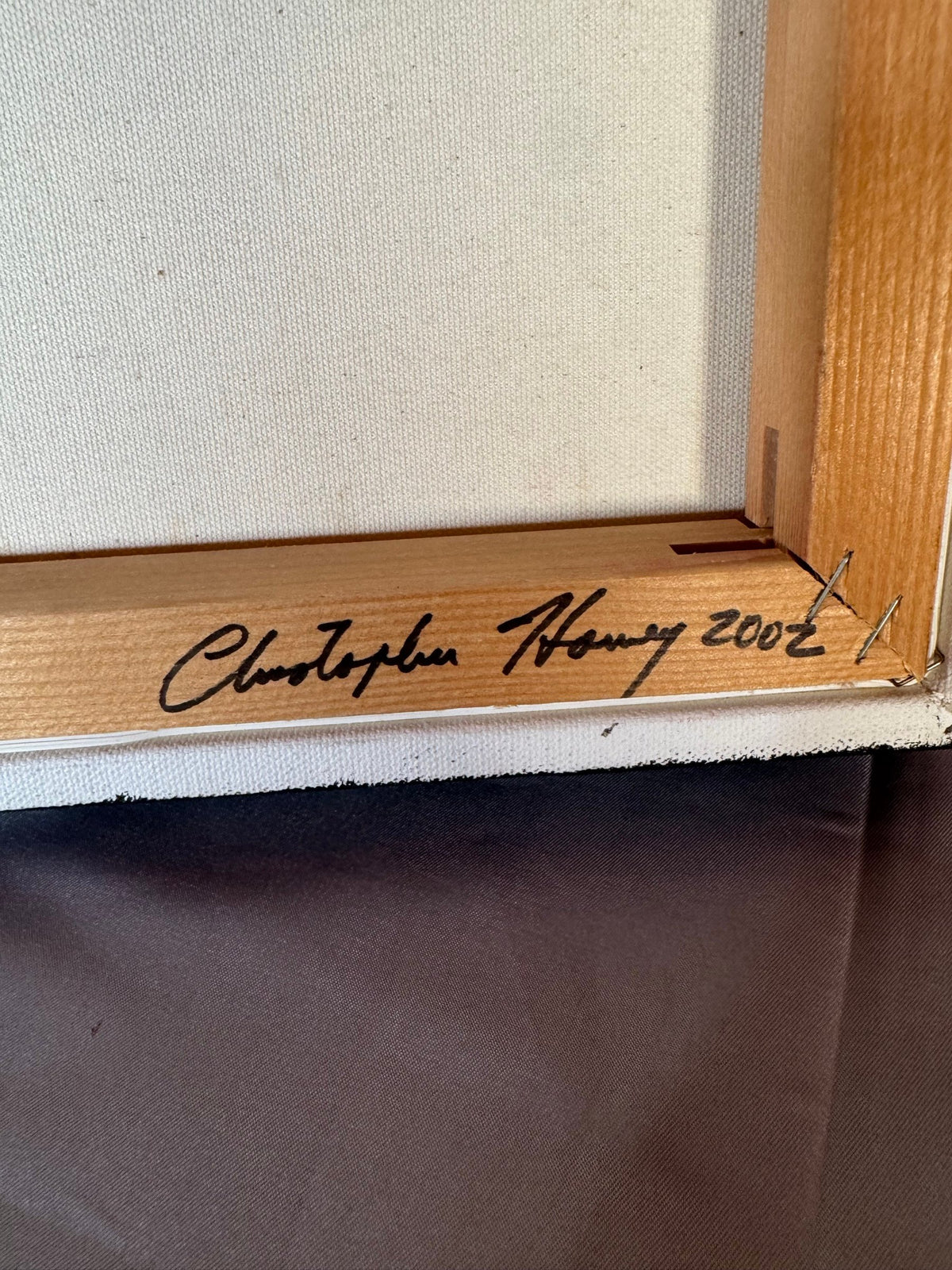 Signature and 2002 date on the stretcher bar