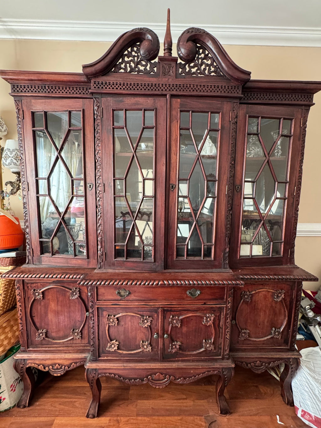 Breakfront china cabinet with lattice-glass doors and swan-neck pediment