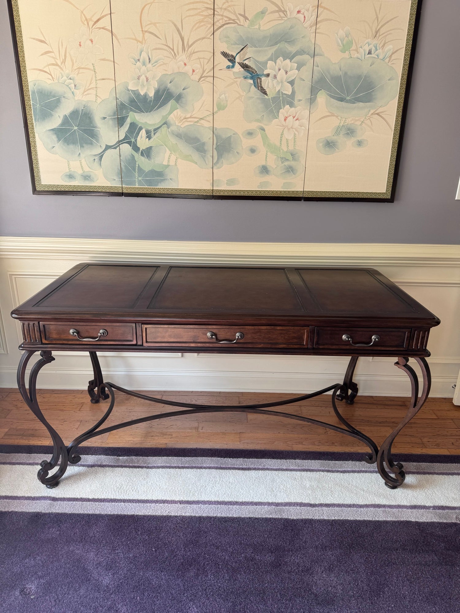 Full front view of wooden desk with three drawers, ornate curved legs, and tooled leather top surface