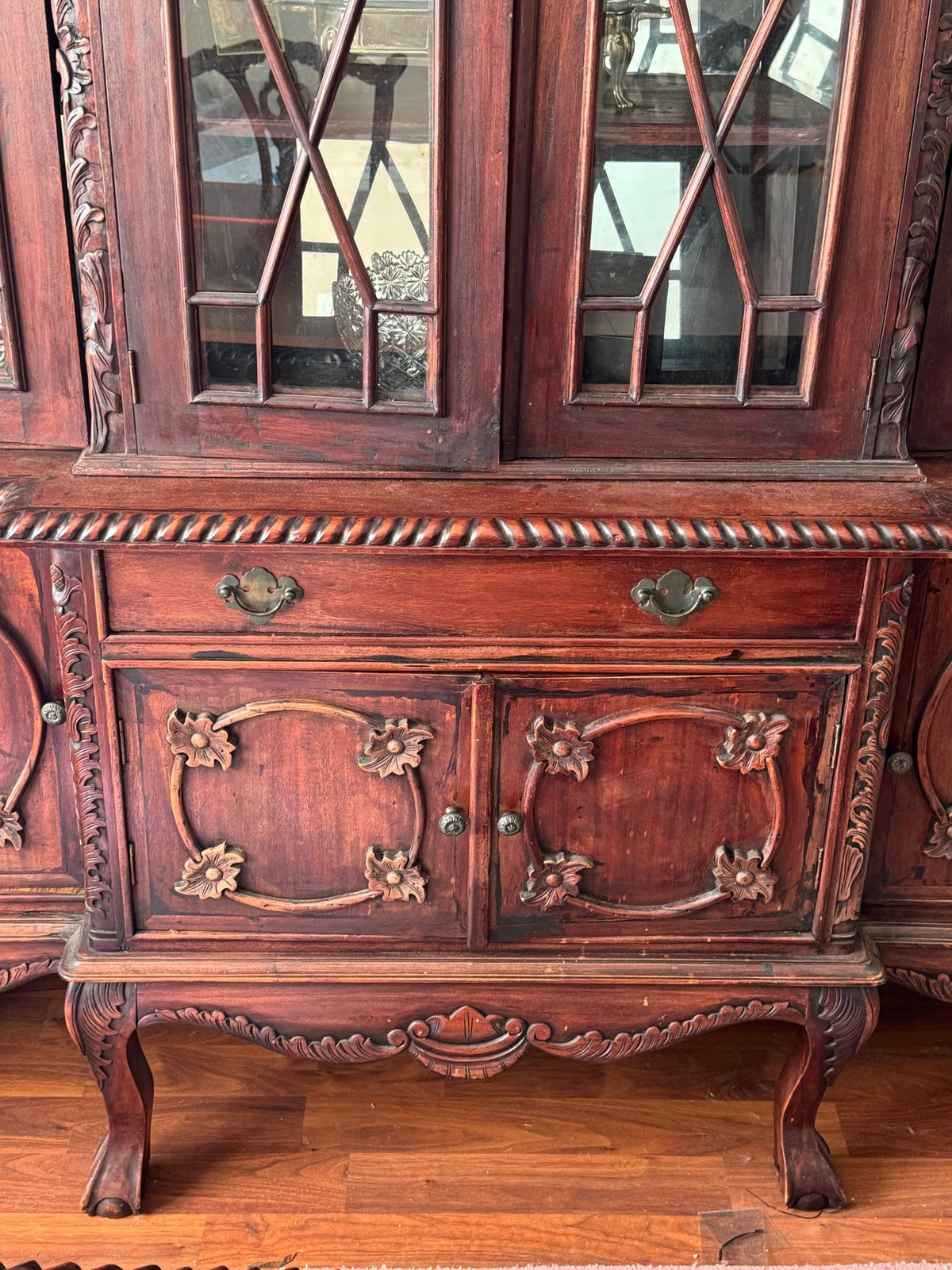 Lower drawer and carved cabinet doors of the china cabinet