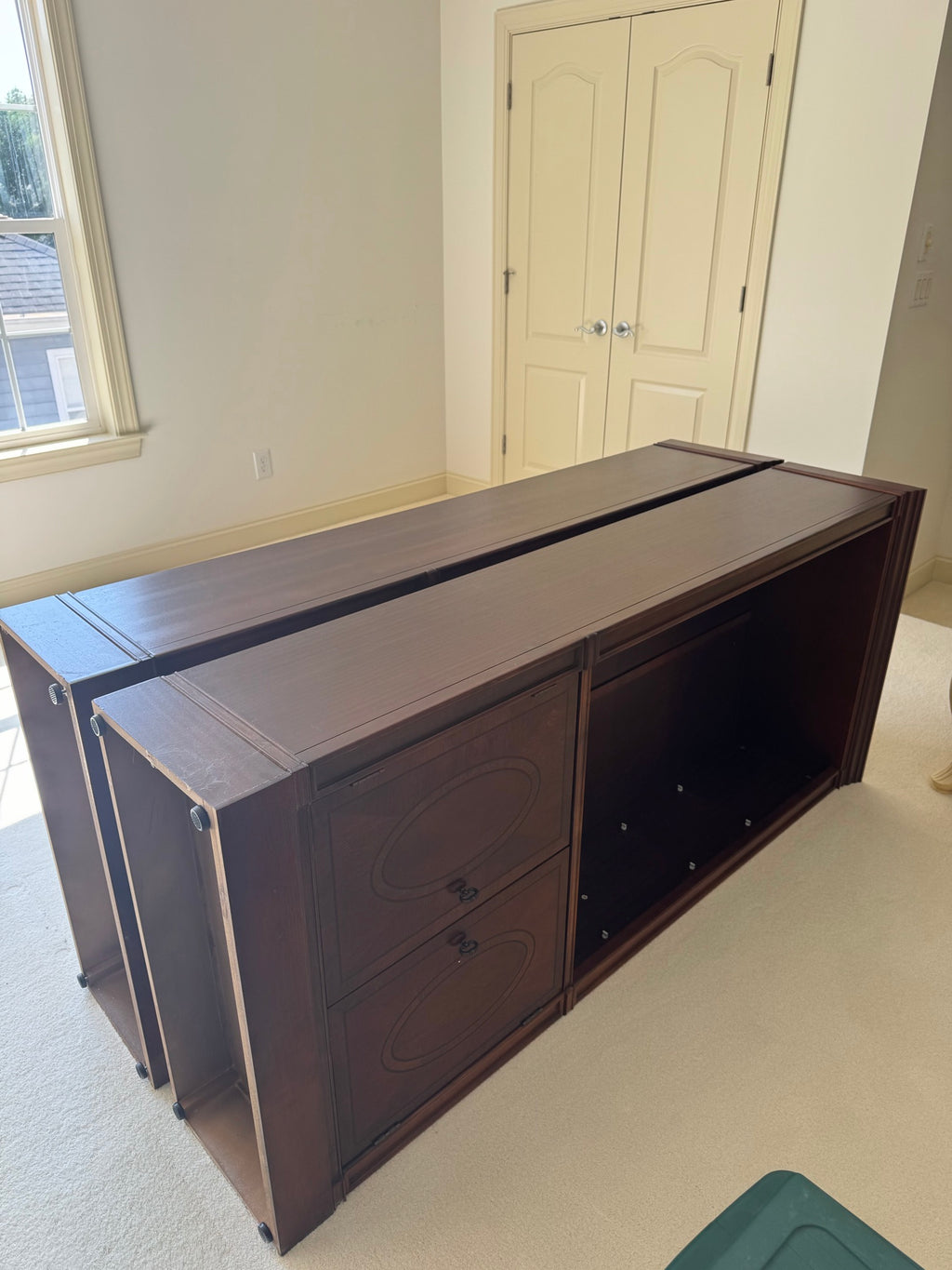 Matching mahogany cabinet base unit with two drawers featuring oval inlaid panels, viewed from front angle