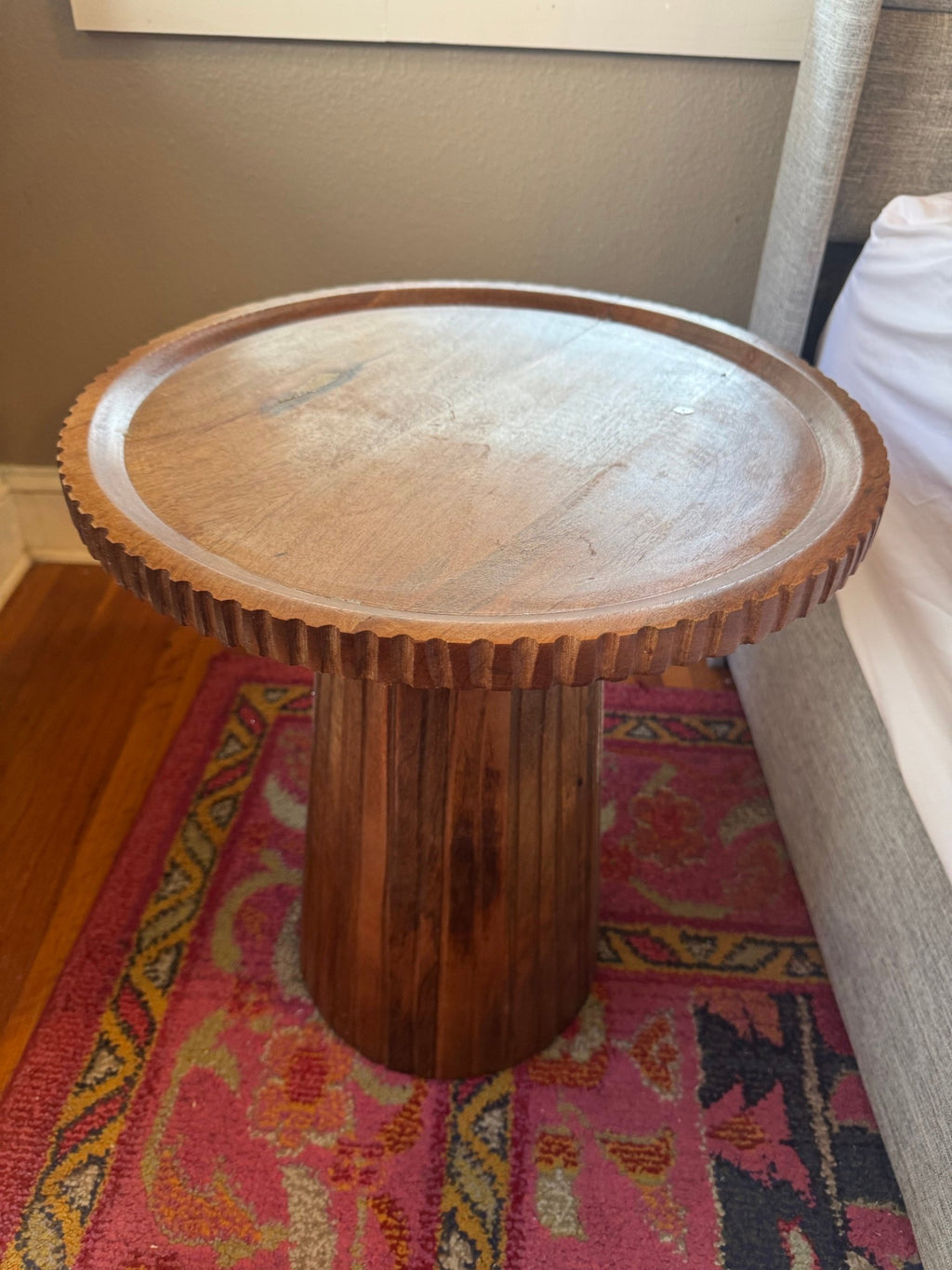Second round side table beside the bed