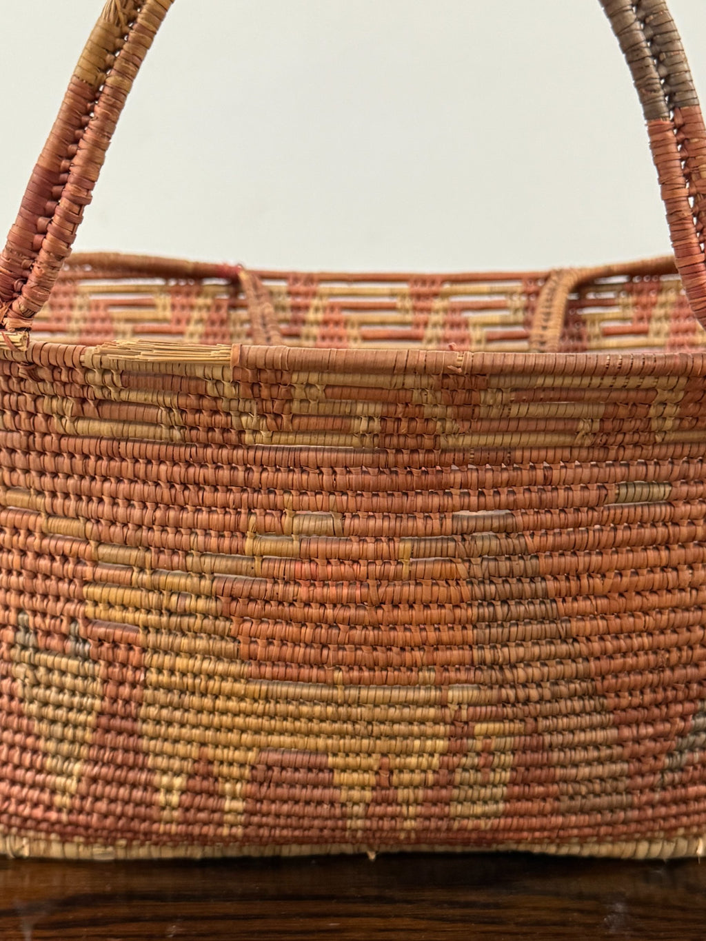 Exterior side view showing graduated horizontal stripes of rust red, tan and natural cream colors