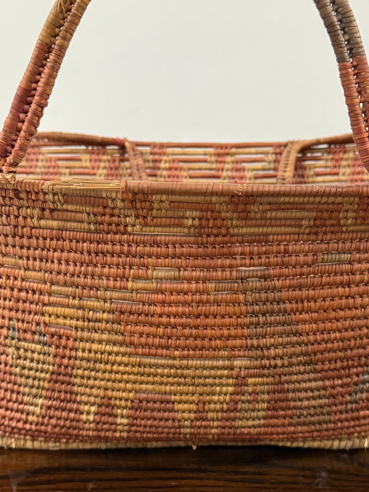 Exterior side view showing graduated horizontal stripes of rust red, tan and natural cream colors